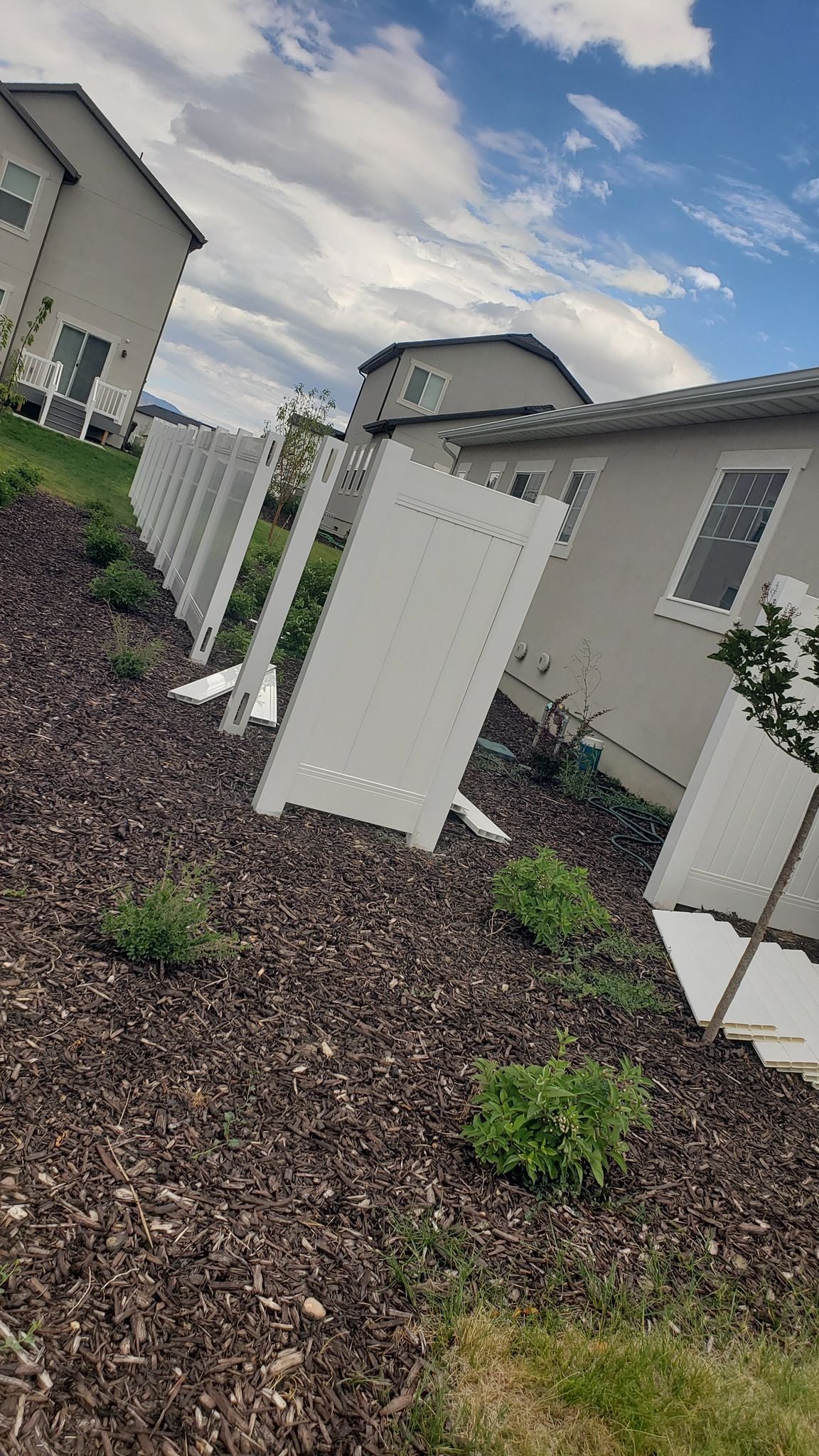 Patino Landscaping Utah finishing fence in yard